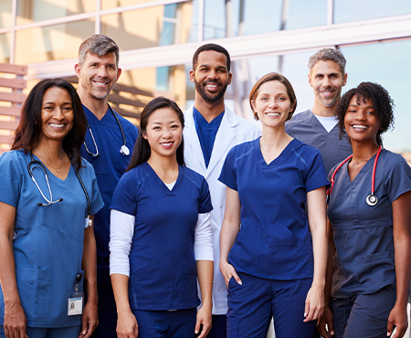 An image showing a diverse group of doctors in white coats, standing together with confident expressions, representing professionalism, expertise, and healthcare teamwork.