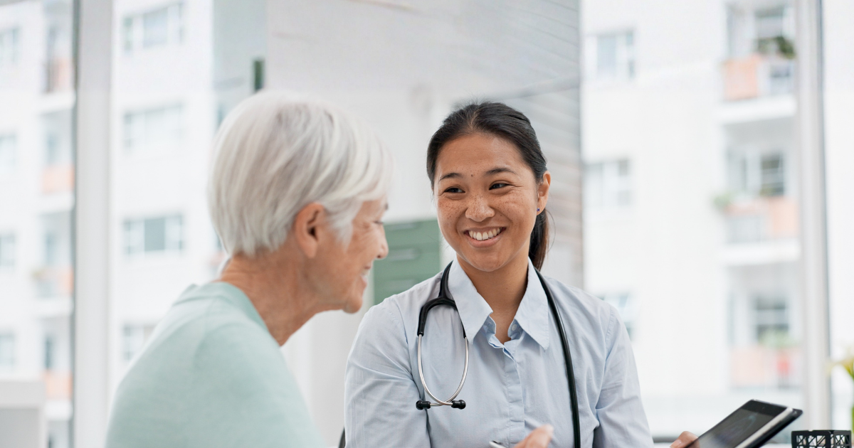 Physician assistant consulting with an older patient in a clinical setting, illustrating PA practice authority and team-based healthcare across the United States.
